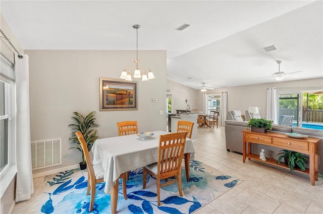 dining room with visible vents, ceiling fan with notable chandelier, and vaulted ceiling