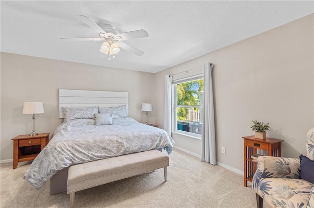 bedroom featuring light colored carpet, baseboards, and ceiling fan