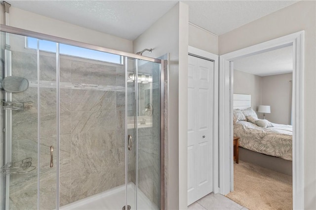 bathroom featuring ensuite bath, a stall shower, and tile patterned floors