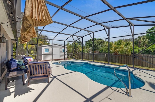 view of swimming pool featuring a fenced backyard, glass enclosure, a storage shed, an outdoor structure, and a patio area