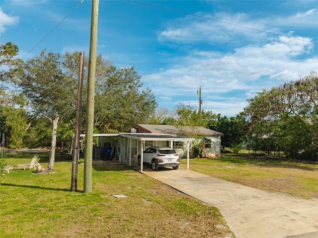 view of front of house with a front lawn and a carport