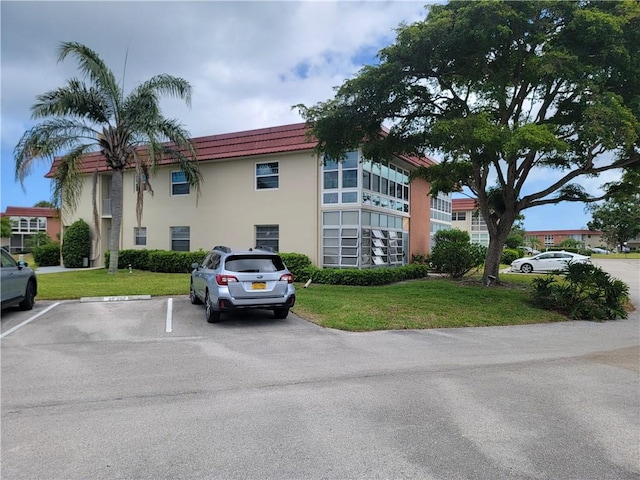 28 Pine Arbor Ln Unit 202, Vero Beach, FL 32962 - view of building exterior with uncovered parking