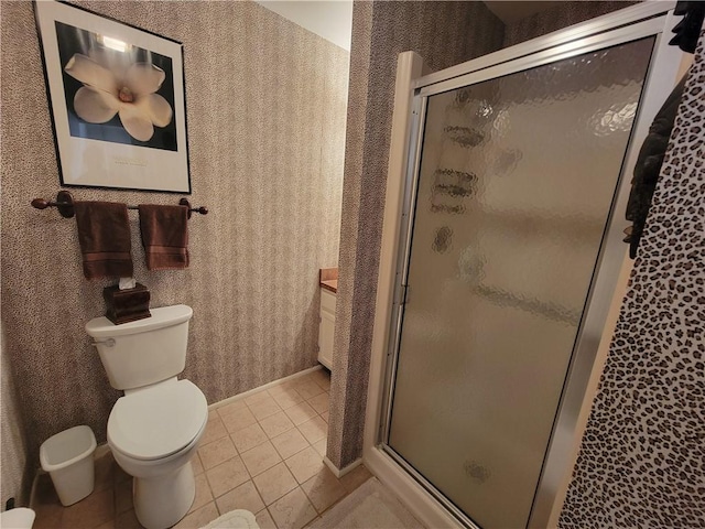 28 Pine Arbor Ln Unit 202, Vero Beach, FL 32962 - full bathroom featuring toilet, a stall shower, tile patterned flooring, and wallpapered walls