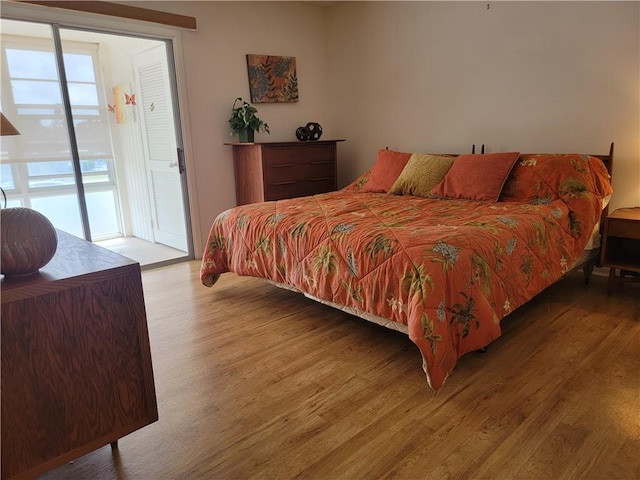 28 Pine Arbor Ln Unit 202, Vero Beach, FL 32962 - bedroom featuring access to exterior and wood finished floors