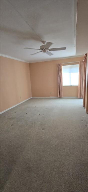 1850 Bay Rd Unit 3F, Vero Beach, FL 32963 - spare room featuring a ceiling fan, crown molding, and carpet flooring