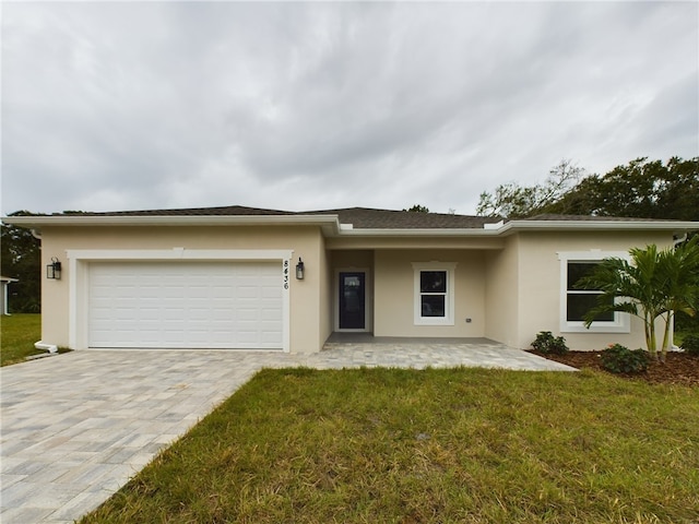 view of front of home with a front yard and a garage