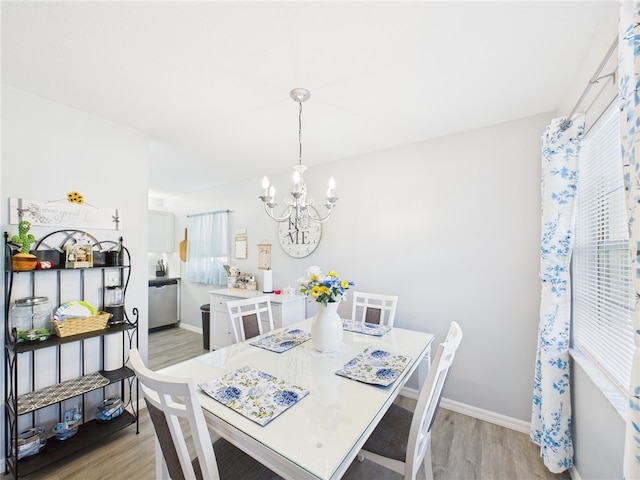 96 Spring Lake Dr Unit 105, Vero Beach, FL 32962 - dining room with a chandelier and light wood finished floors