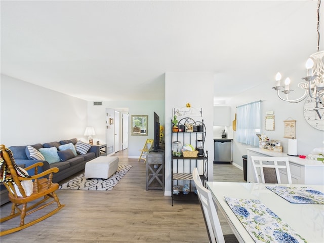 96 Spring Lake Dr Unit 105, Vero Beach, FL 32962 - living area featuring a chandelier and light wood-type flooring