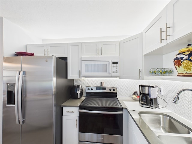 96 Spring Lake Dr Unit 105, Vero Beach, FL 32962 - kitchen with stainless steel appliances and backsplash