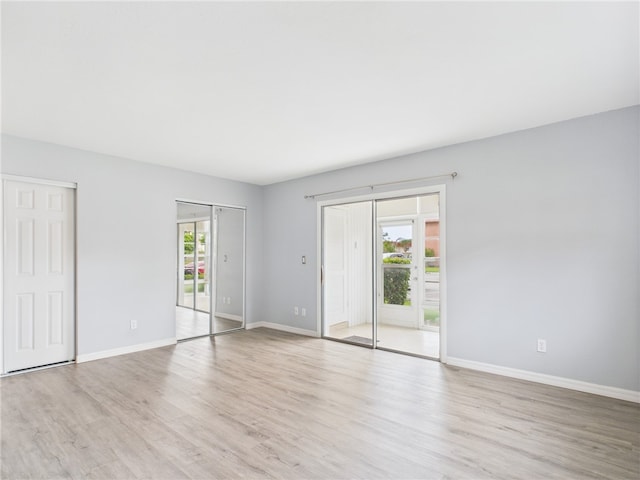96 Spring Lake Dr Unit 105, Vero Beach, FL 32962 - unfurnished bedroom featuring access to exterior and light wood-type flooring