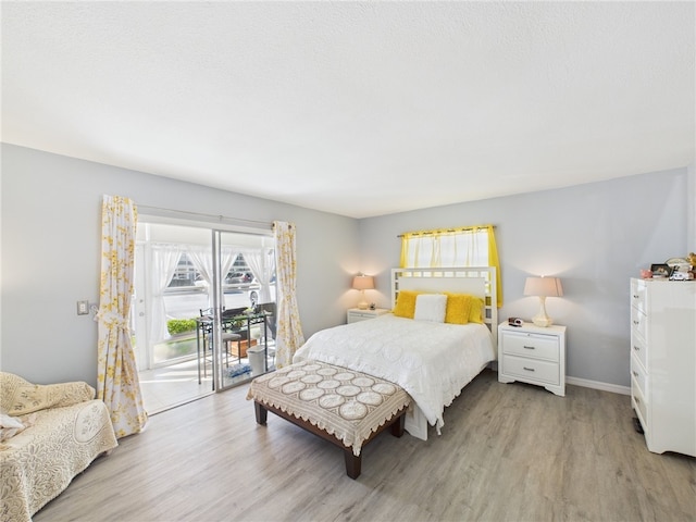 96 Spring Lake Dr Unit 105, Vero Beach, FL 32962 - bedroom with access to exterior and light wood-type flooring