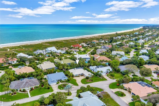 bird's eye view with a water view, a residential view, and a view of the beach