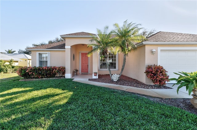 view of front of house featuring a garage and a front yard