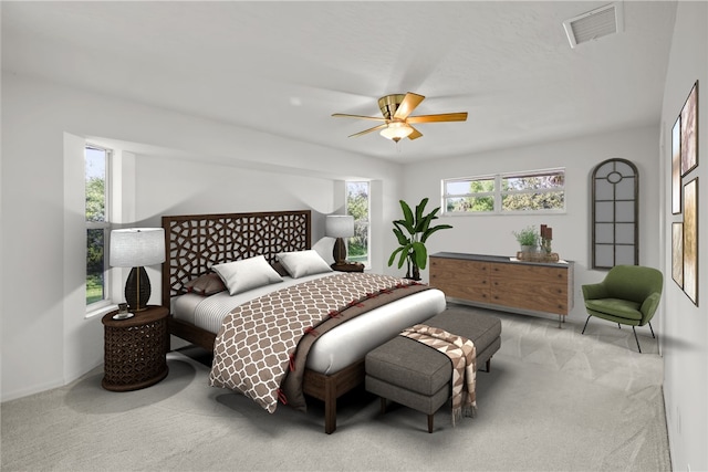 bedroom with ceiling fan and light carpet