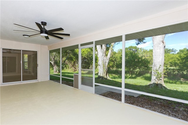 unfurnished sunroom with a wealth of natural light and ceiling fan