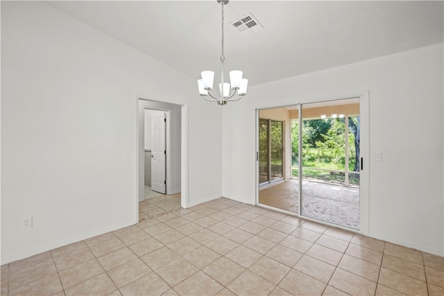 tiled empty room with a notable chandelier and vaulted ceiling