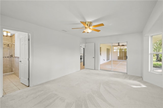 carpeted empty room featuring ceiling fan