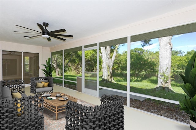 sunroom featuring ceiling fan and plenty of natural light