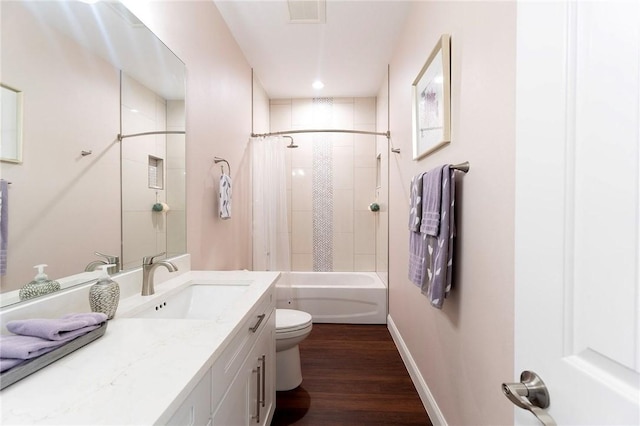 full bathroom with toilet, vanity, wood finished floors, shower / bathtub combination with curtain, and baseboards