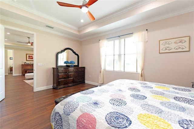 bedroom featuring dark wood-type flooring, crown molding, baseboards, recessed lighting, and a tray ceiling