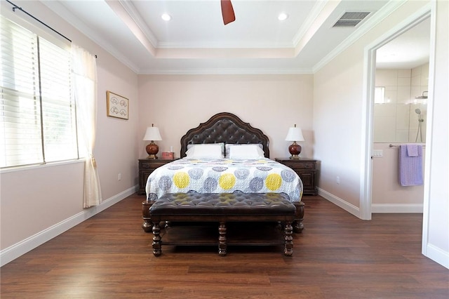 bedroom featuring multiple windows, wood finished floors, a tray ceiling, baseboards, and recessed lighting