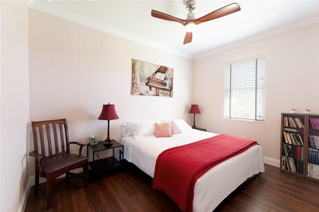 bedroom featuring wood finished floors, crown molding, baseboards, and ceiling fan