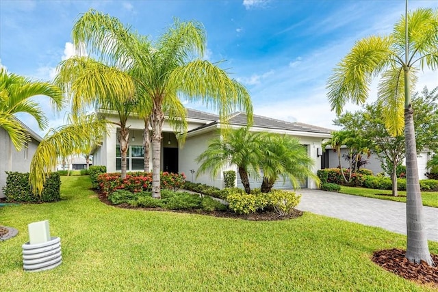 11706 SW Brighton Falls Dr, Port St Lucie, FL 34987 - view of front of home with a garage, decorative driveway, stucco siding, and a front yard