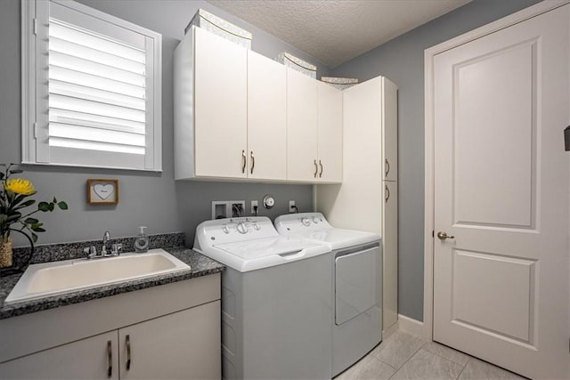 11706 SW Brighton Falls Dr, Port St Lucie, FL 34987 - washroom featuring washing machine and dryer, cabinet space, and a textured ceiling