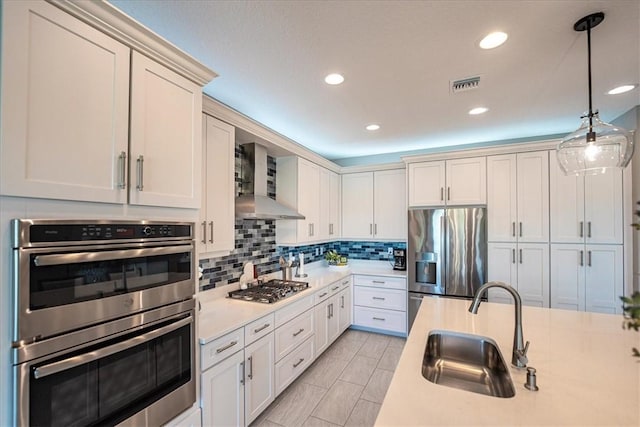 11706 SW Brighton Falls Dr, Port St Lucie, FL 34987 - kitchen with stainless steel appliances, light countertops, backsplash, decorative light fixtures, and recessed lighting