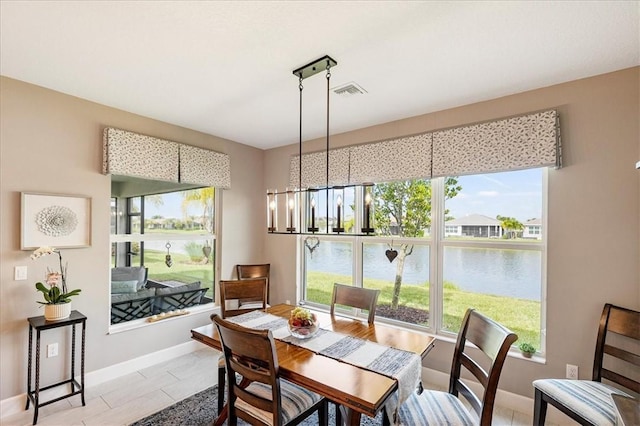 11706 SW Brighton Falls Dr, Port St Lucie, FL 34987 - dining room with healthy amount of natural light, a water view, and a chandelier