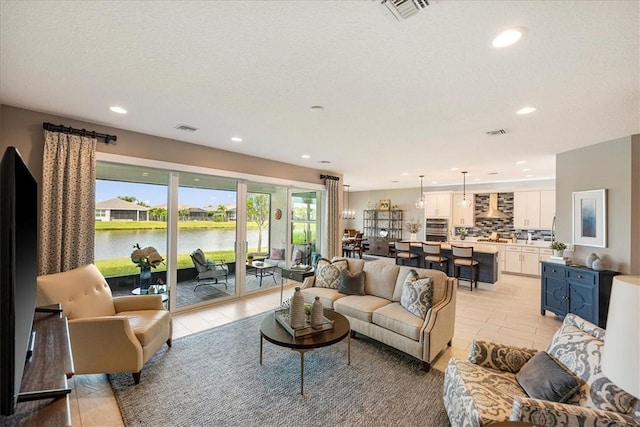 11706 SW Brighton Falls Dr, Port St Lucie, FL 34987 - living room featuring recessed lighting and light tile patterned floors