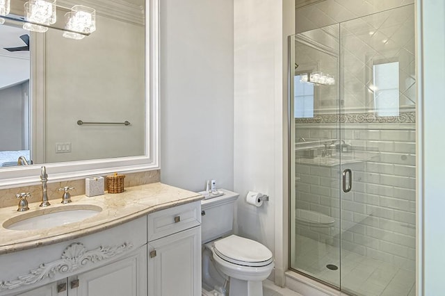 bathroom with toilet, a shower with door, crown molding, and vanity