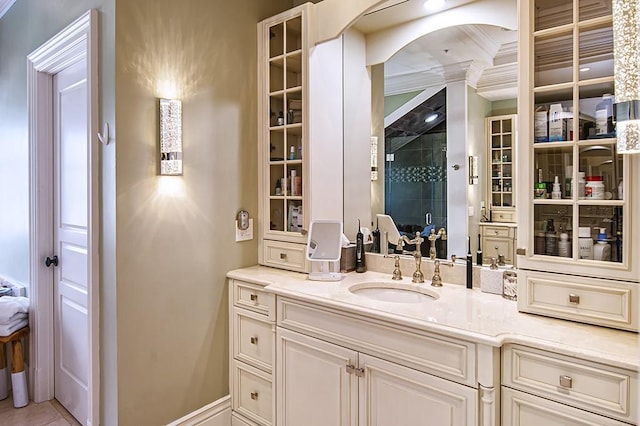 bathroom with a shower with door, ornamental molding, tile patterned floors, and vanity