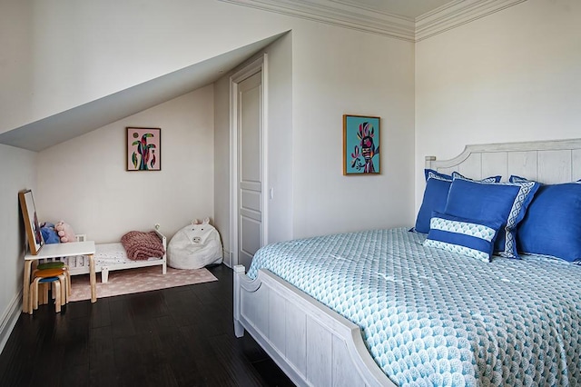 bedroom with lofted ceiling, ornamental molding, and dark hardwood / wood-style floors