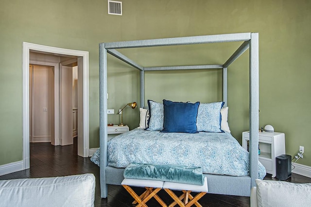 bedroom with dark wood-type flooring