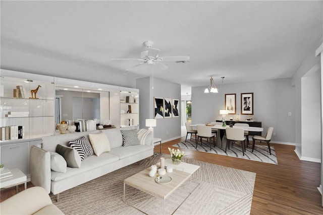 640 N Centre Ct SW Unit 102, Vero Beach, FL 32962 - living area featuring wood finished floors, a ceiling fan, and a chandelier