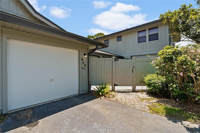 640 N Centre Ct SW Unit 102, Vero Beach, FL 32962 - garage with asphalt driveway and a gate