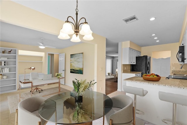 640 N Centre Ct SW Unit 102, Vero Beach, FL 32962 - dining area featuring a chandelier, a ceiling fan, recessed lighting, and built in shelves
