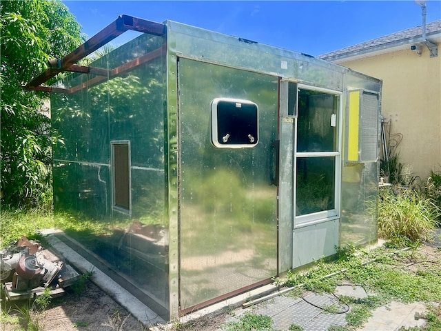 view of side of property with an outbuilding