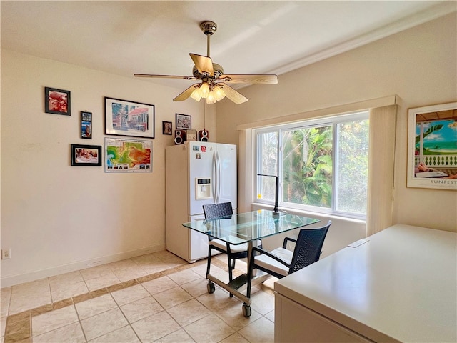 tiled dining room featuring ceiling fan