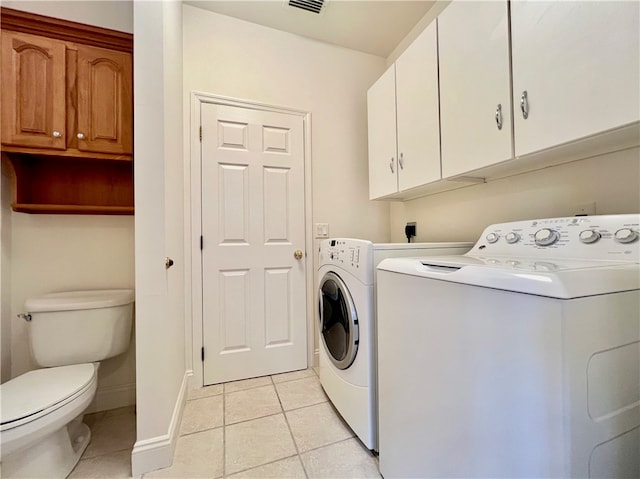 laundry area featuring light tile patterned floors and washer and clothes dryer