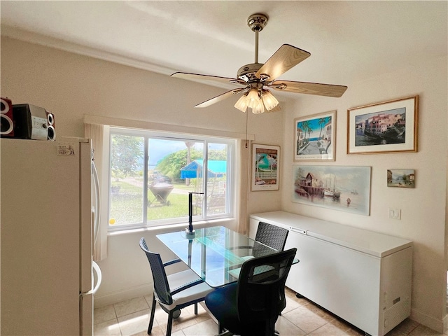 dining space with ceiling fan and light tile patterned floors