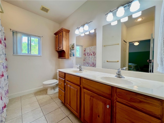 bathroom featuring toilet, vanity, and tile patterned floors