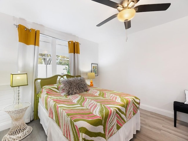 bedroom with hardwood / wood-style floors and ceiling fan