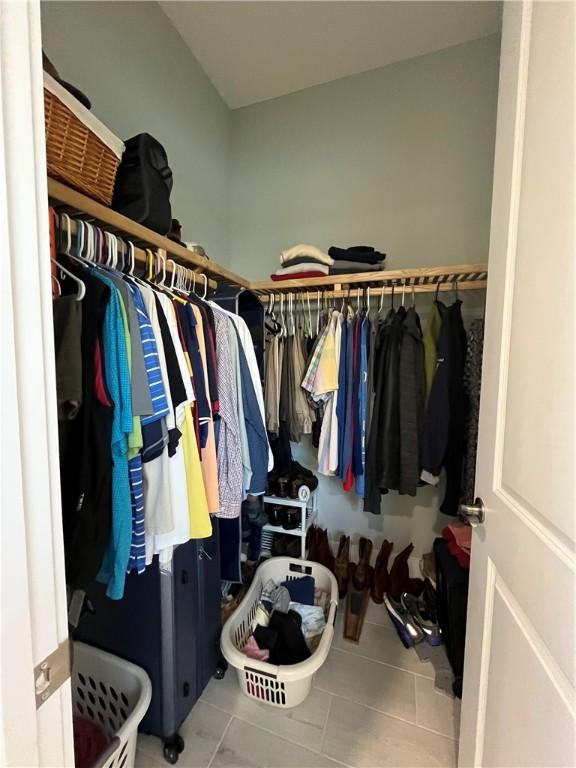 spacious closet featuring tile patterned flooring