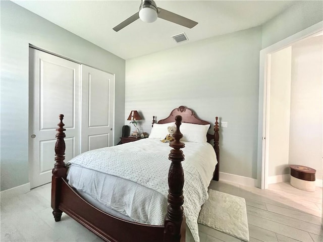 bedroom featuring light hardwood / wood-style flooring, a closet, and ceiling fan