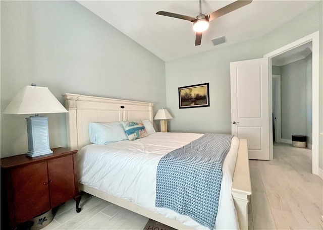 bedroom featuring lofted ceiling, light hardwood / wood-style flooring, and ceiling fan