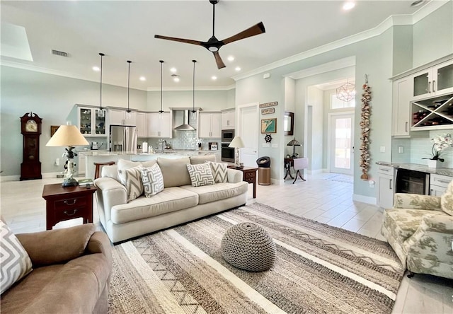 living room with crown molding, beverage cooler, and ceiling fan