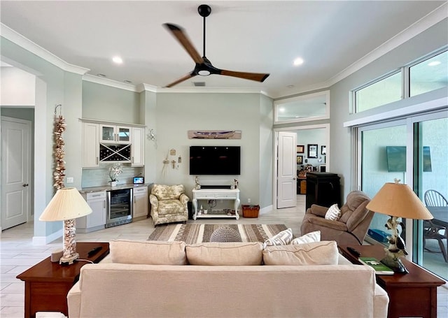 living room with wine cooler, indoor bar, ornamental molding, and ceiling fan