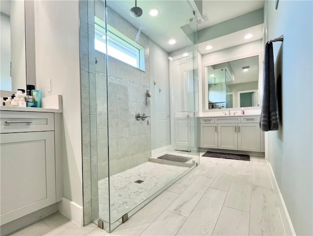 bathroom featuring vanity and tiled shower